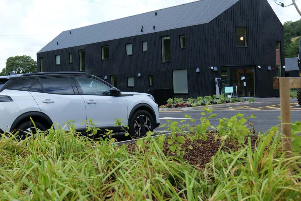 Large black timber-clad two-storey building at the new Pontneddfechan visitor hub"