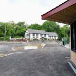New timber-clad visitor hub buildings at Pontneddfechan with The Angel pub in the background