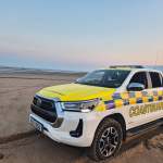 A Port Talbot Coastguard 4x4 search and rescue vehicle parked on the sand at dusk near the River Neath