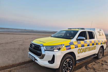 A Port Talbot Coastguard 4x4 search and rescue vehicle parked on the sand at dusk near the River Neath