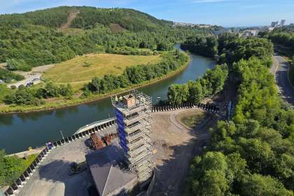 Aerial view from the top of the scaffolded copperworks chimney, with the River Tawe, woodland and Swansea in the distance