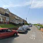 A Google Street View image of Elphin Gardens in Townhill, Swansea, a residential street of semi-detached houses on a hillside