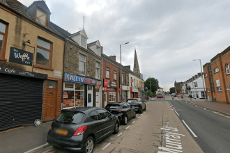 A Google Street View image of Murray Street in Llanelli, with the All In One takeaway among a row of shops and cars parked outside