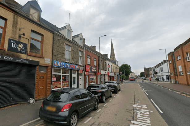 A Google Street View image of Murray Street in Llanelli, with the All In One takeaway among a row of shops and cars parked outside