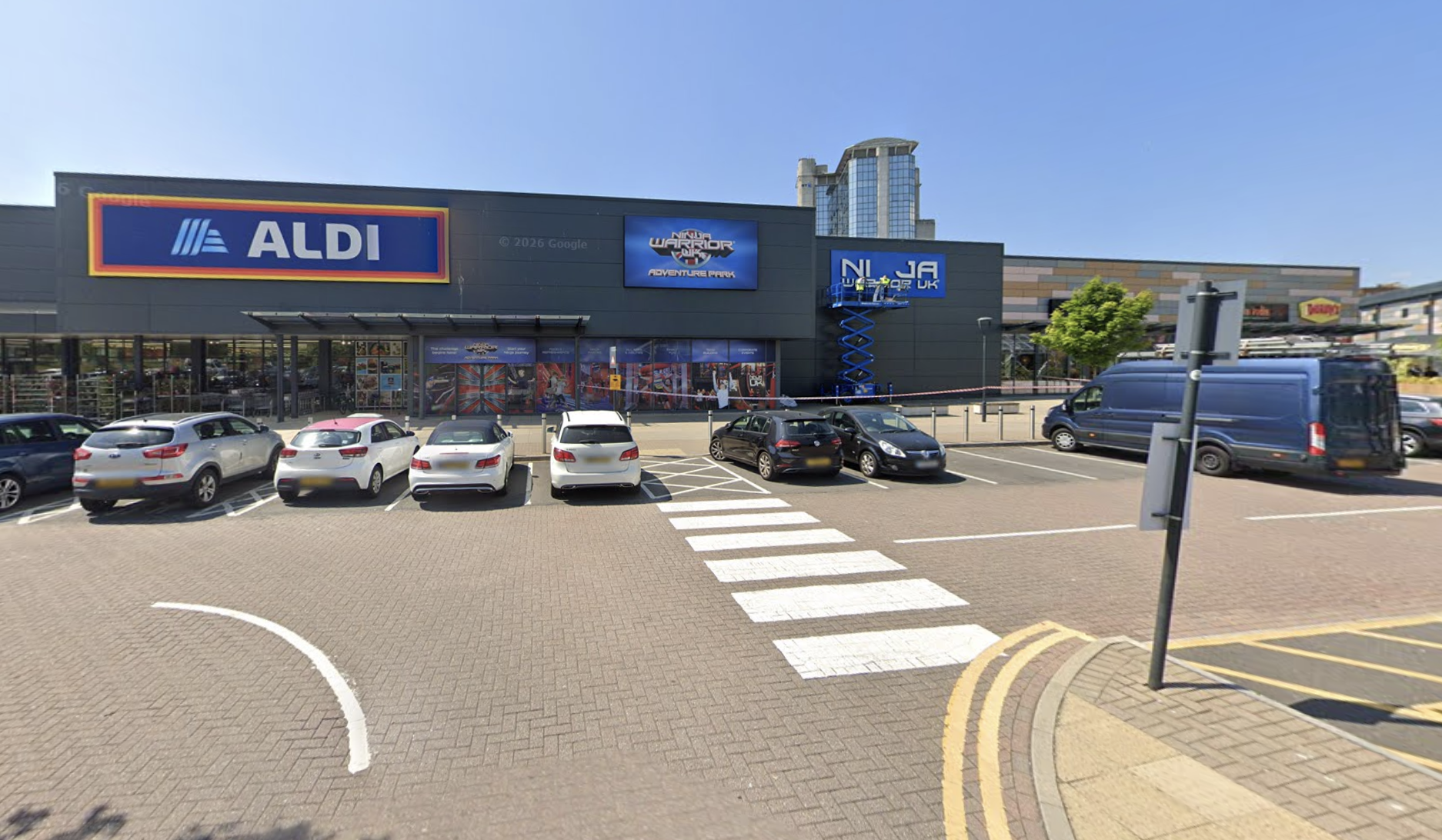 The frontage of the Parc Tawe unit shared by Aldi and Ninja Warrior UK Adventure Park, with cars parked outside
