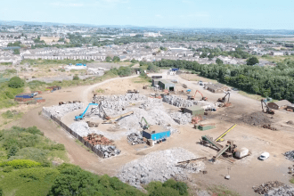 Wide aerial view of the AMG Resources site in Llanelli with the town in the background