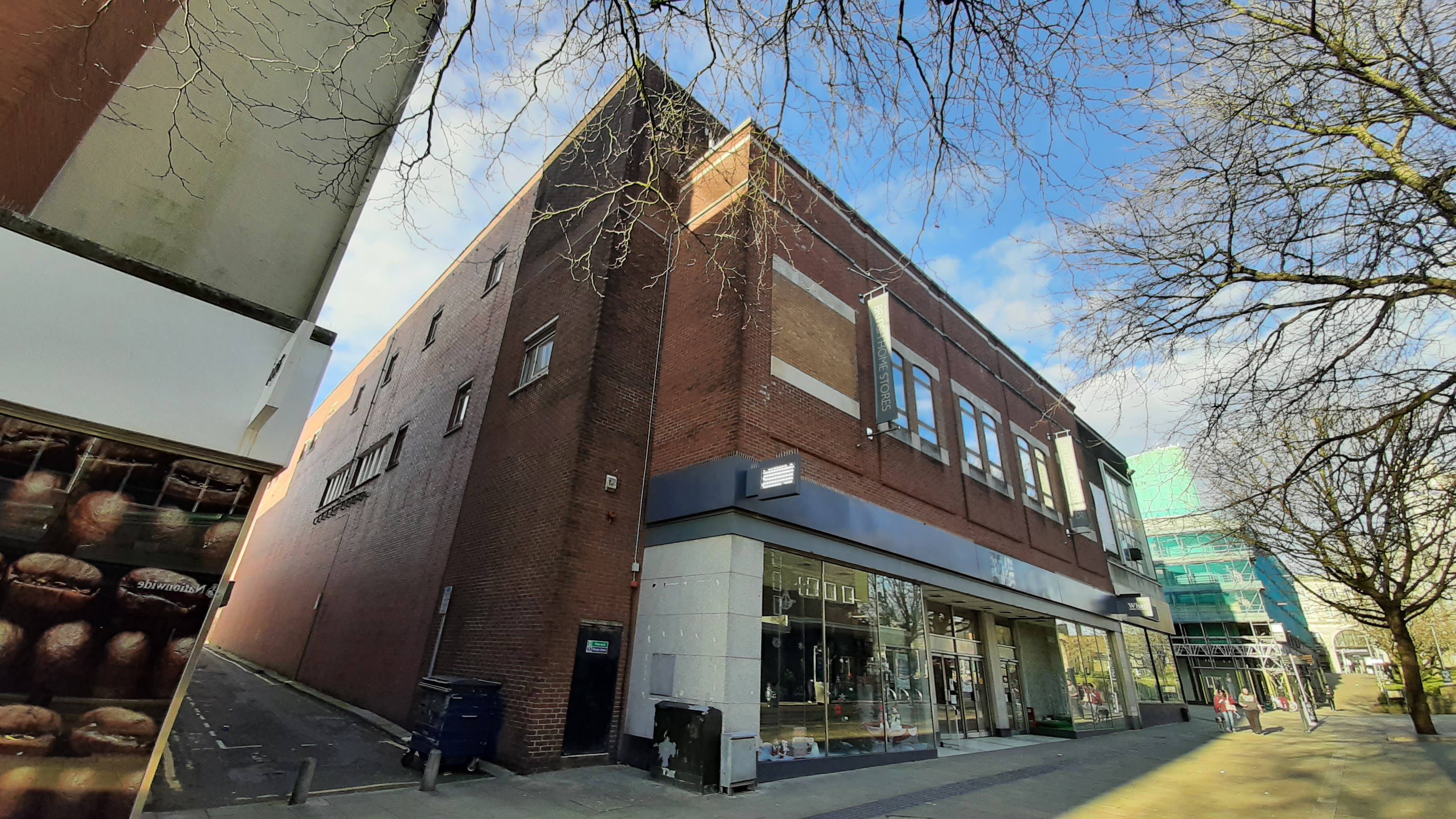 The red-brick former BHS department store building in Swansea city centre before its transformation, with empty shop windows