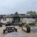 Exterior of the Bagle Brook Beefeater in Baglan, showing the sign, entrance and picnic benches
