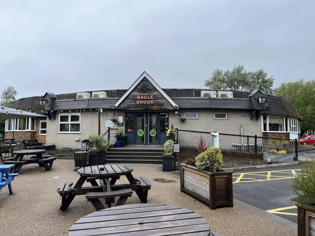 Exterior of the Bagle Brook Beefeater in Baglan, showing the sign, entrance and picnic benches
