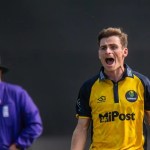 Glamorgan bowler Andy Gorvin appeals in his yellow and navy one-day kit as an umpire looks on