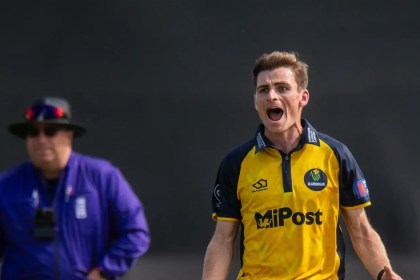Glamorgan bowler Andy Gorvin appeals in his yellow and navy one-day kit as an umpire looks on