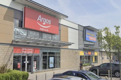 The Argos store front at Parc Pemberton retail park in Llanelli, with a bilingual Hello Llanelli sign beside the entrance