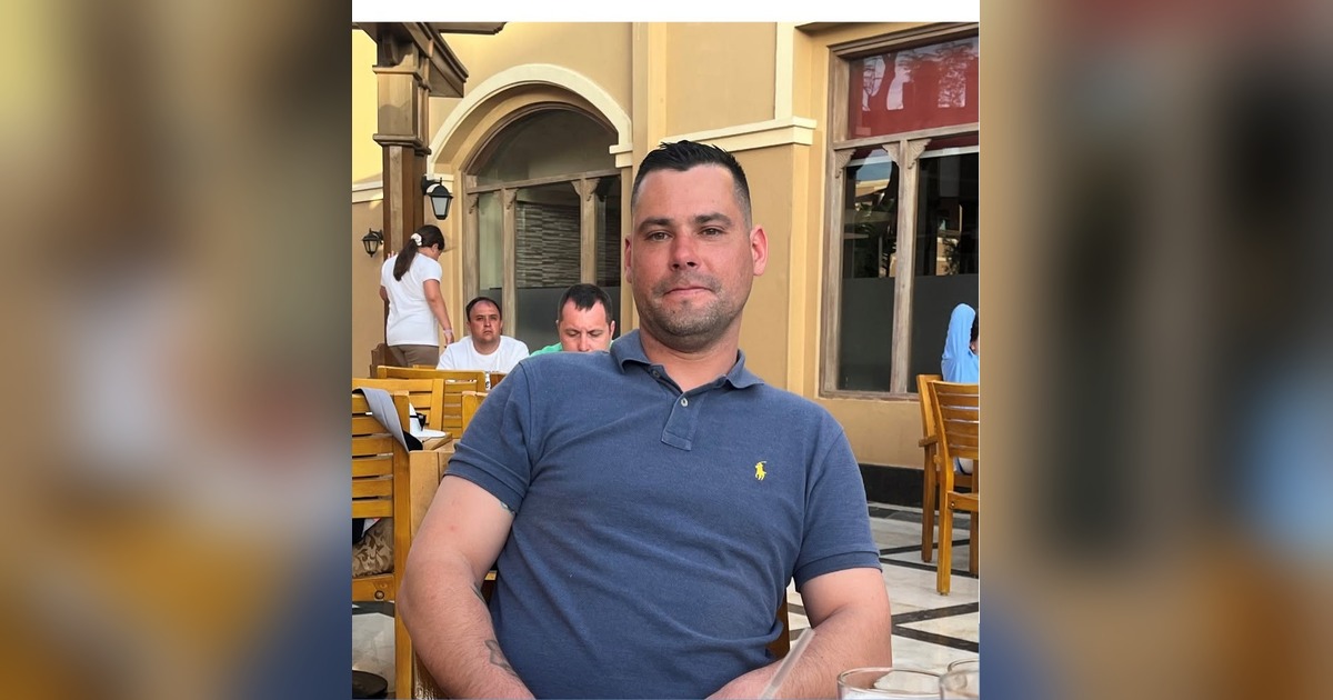 Ashley Wayne Keane, wearing a blue polo shirt, in a photo released by his family through Dyfed-Powys Police