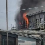 Flames and black smoke rising from a scaffolded section of Awel y Môr Primary School in Port Talbot