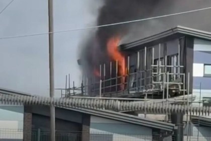 Flames and black smoke rising from a scaffolded section of Awel y Môr Primary School in Port Talbot