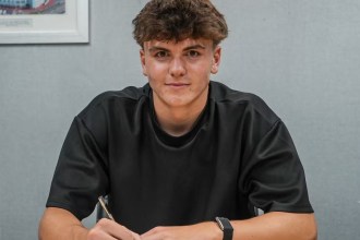 Carter Heywood signing his first professional contract at Swansea City.