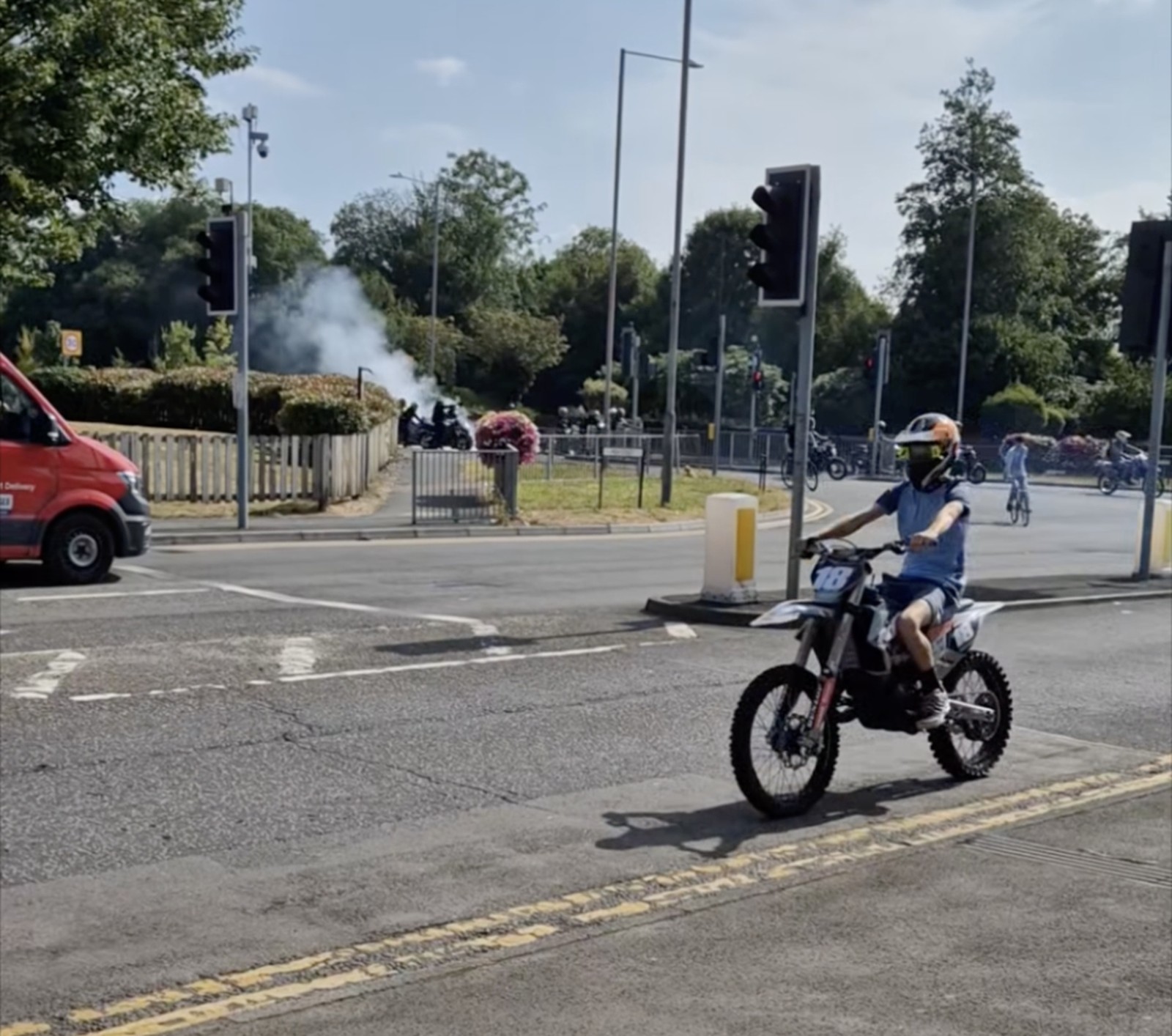 A rider on a dirt bike passing a traffic light junction during the memorial ride-out