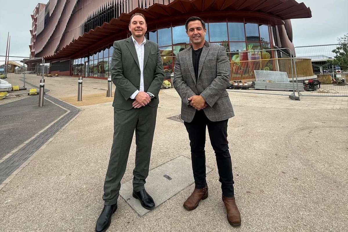 Cllr Andrew Stevens and council leader Rob Stewart standing outside the glazed Cupid Way units beneath the Copr Bay North car park