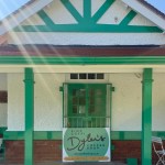 The green and white pavilion in Cwmdonkin Park with the Dylan's Coffee Shop sign at its entrance