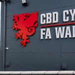 The FA Wales and CBD Cymru sign with the red dragon crest on the wall of the association's headquarters building