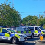 Four South Wales Police vehicles parked across a road junction in Gorseinon