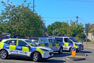 Four South Wales Police vehicles parked across a road junction in Gorseinon