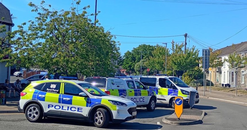Four South Wales Police vehicles parked across a road junction in Gorseinon