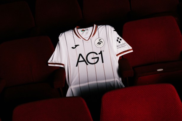 The new Swansea City 2026-27 home shirt laid out on a red seat in the Grand Theatre