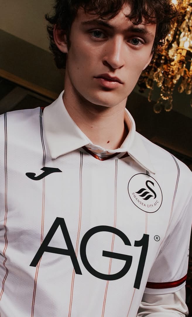 A model wearing the new Swansea City home shirt over a white collared shirt