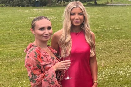 Nurses Kelsey Pirie and Emma Brown in wedding outfits standing on the lawn at Bryngarw House