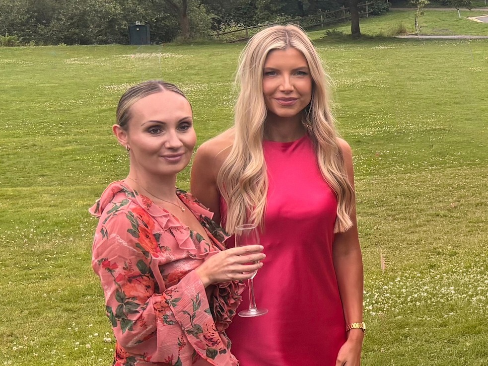 Nurses Kelsey Pirie and Emma Brown in wedding outfits standing on the lawn at Bryngarw House