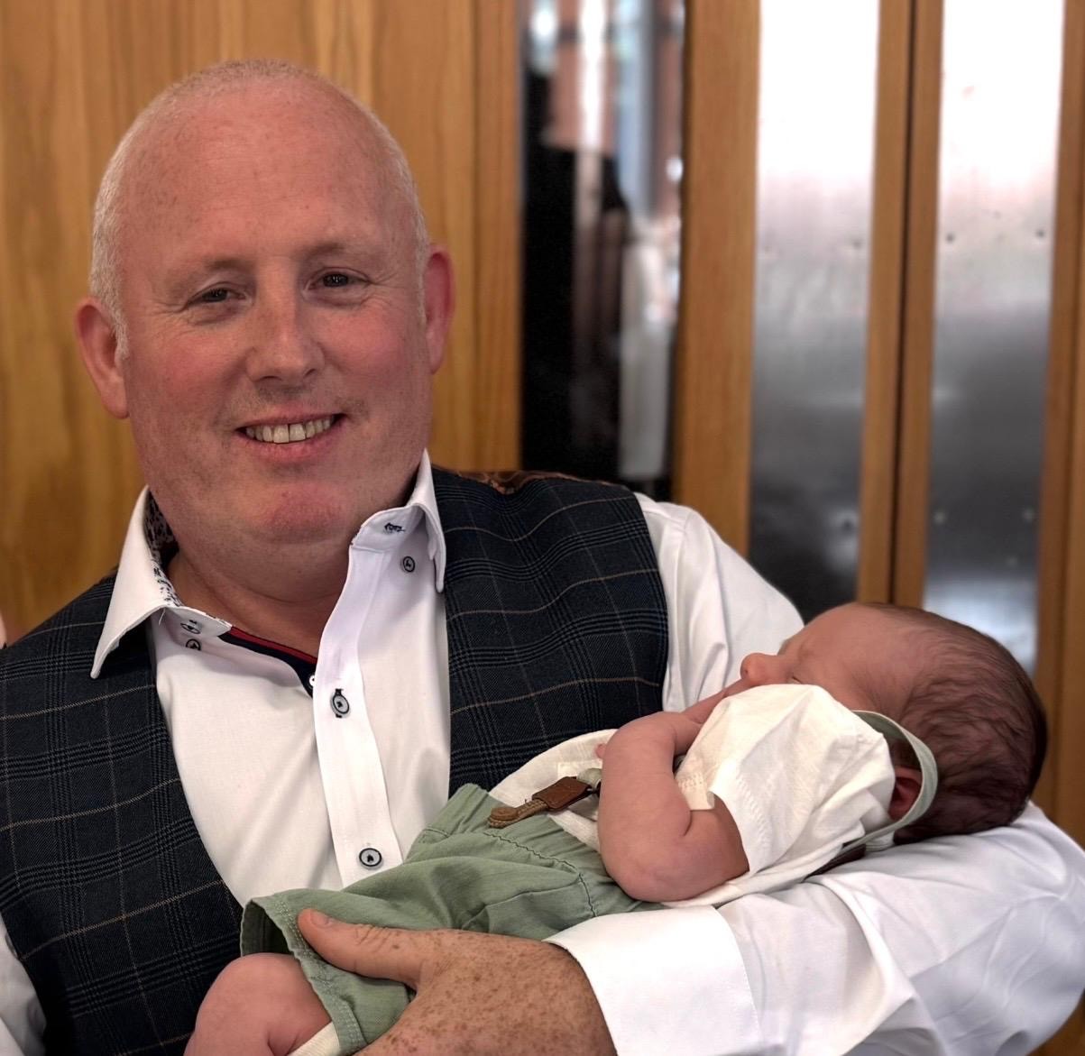 Lee Brain holding his newborn grandson Cian Lee Joseph Page
