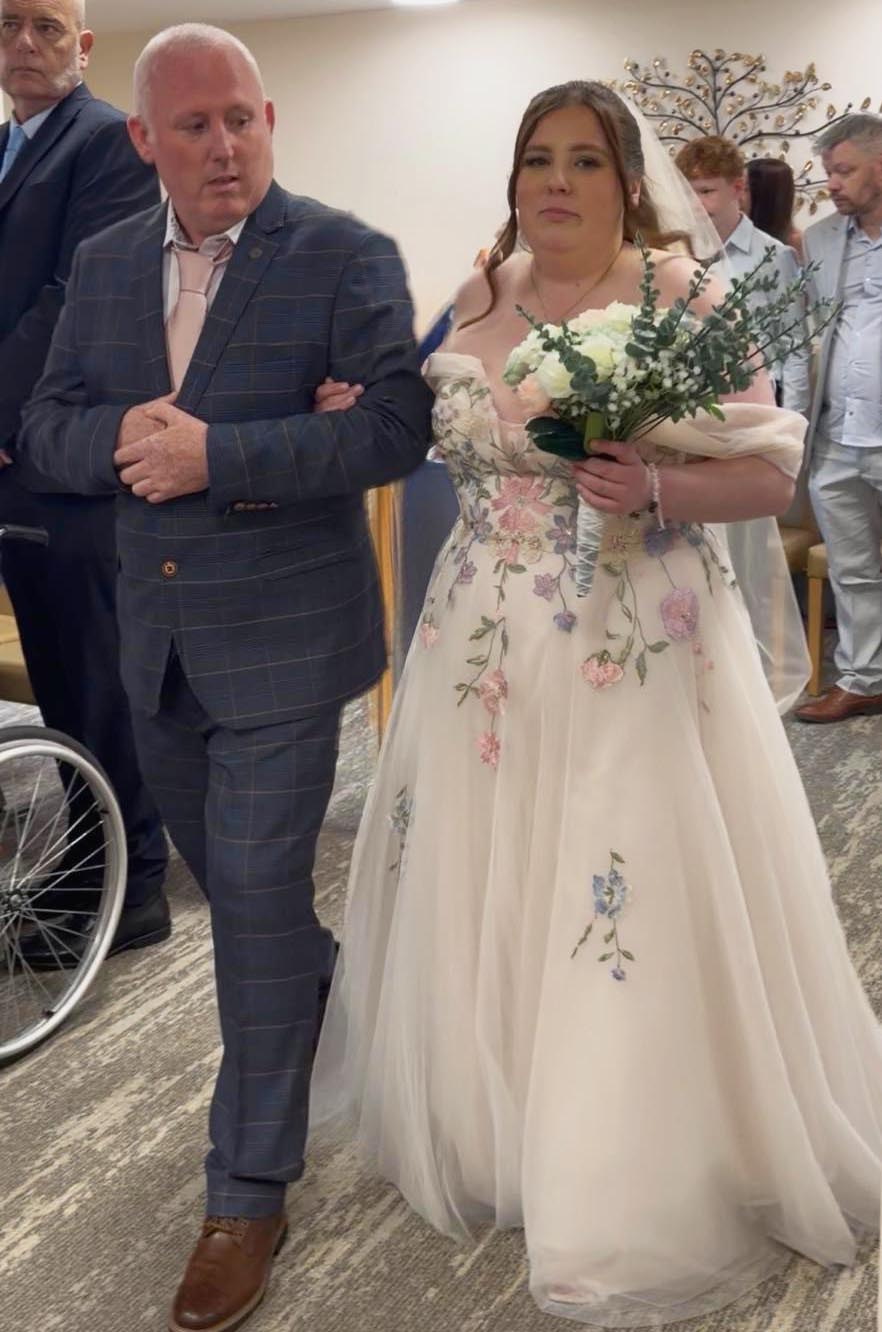 Lee Brain walking his daughter Cody down the aisle on her wedding day