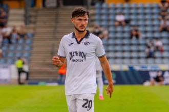 Liam Cullen on the pitch in Swansea City's white kit during the pre-season tour of Austria