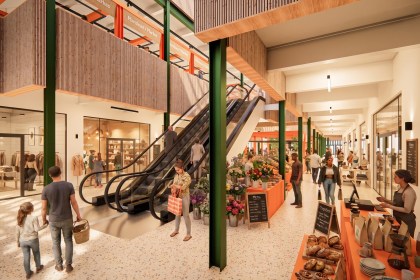 Architect's visualisation of the main entrance atrium inside the proposed Llanelli Market Hall, with orange-framed market stalls, timber-lined balconies and shoppers