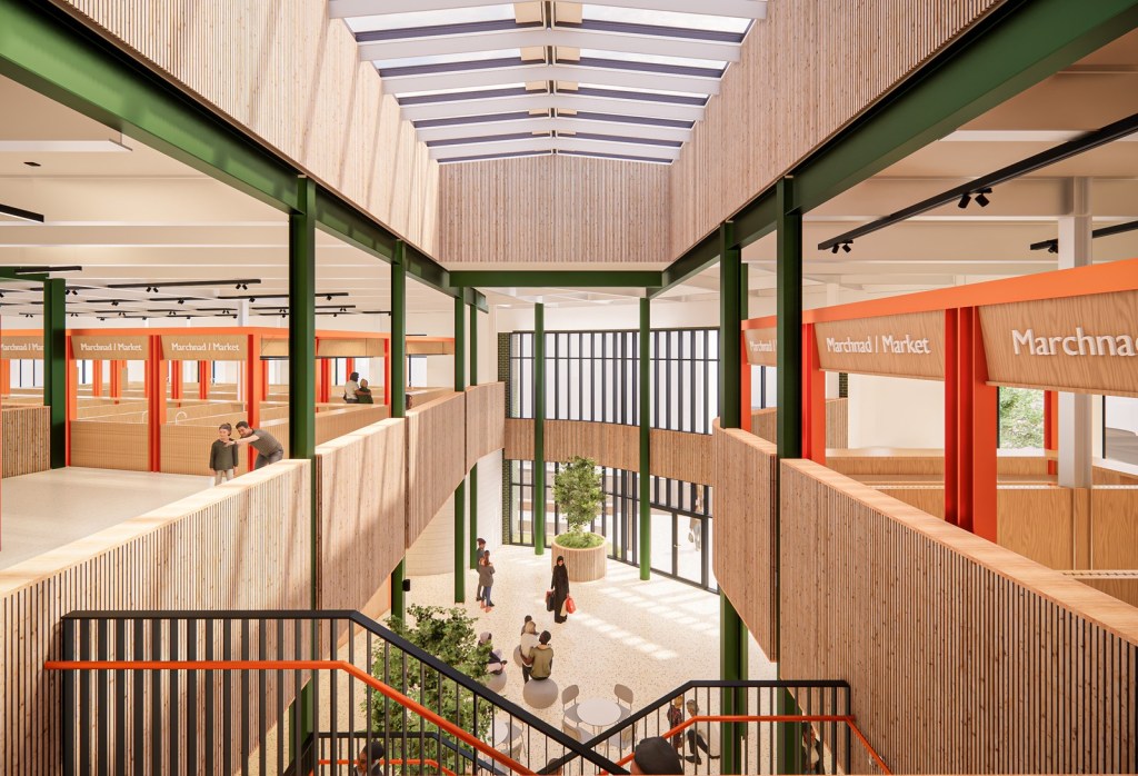 Architect's visualisation looking across the central void of the proposed Llanelli Market Hall from the first floor, with orange-framed stalls and a glazed roof