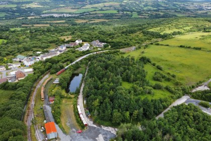 Aerial view of the Llanelli and Mynydd Mawr Railway heritage line and rolling stock at Cynheidre, surrounded by fields and woodland
