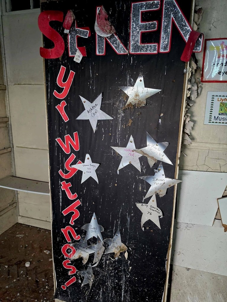 Seren yr Wythnos star of the week display board with silver stars in a derelict Welsh school