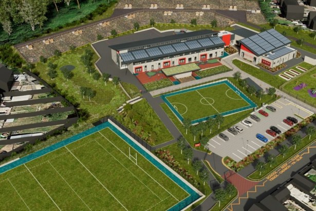 An aerial artist impression of the new Mynydd Cynffig Primary School at Kenfig Hill, showing the school building with solar panels, sports pitches, play areas and a car park
