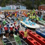 Colourful homemade rafts and crews in fancy dress at the Knab Rock slipway, with crowds watching behind