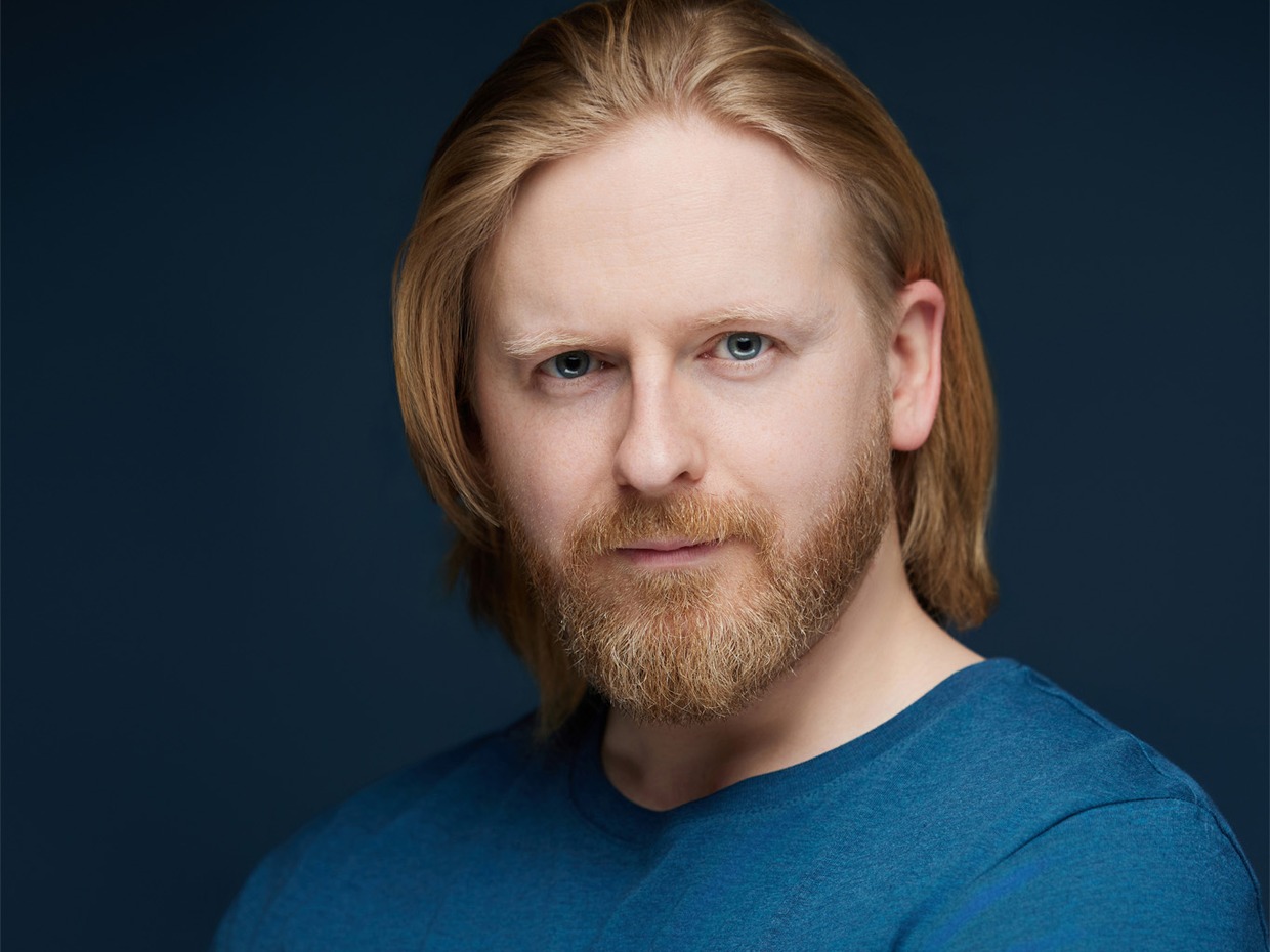 Actor Richard Goss, from Swansea, in a blue t-shirt against a dark background