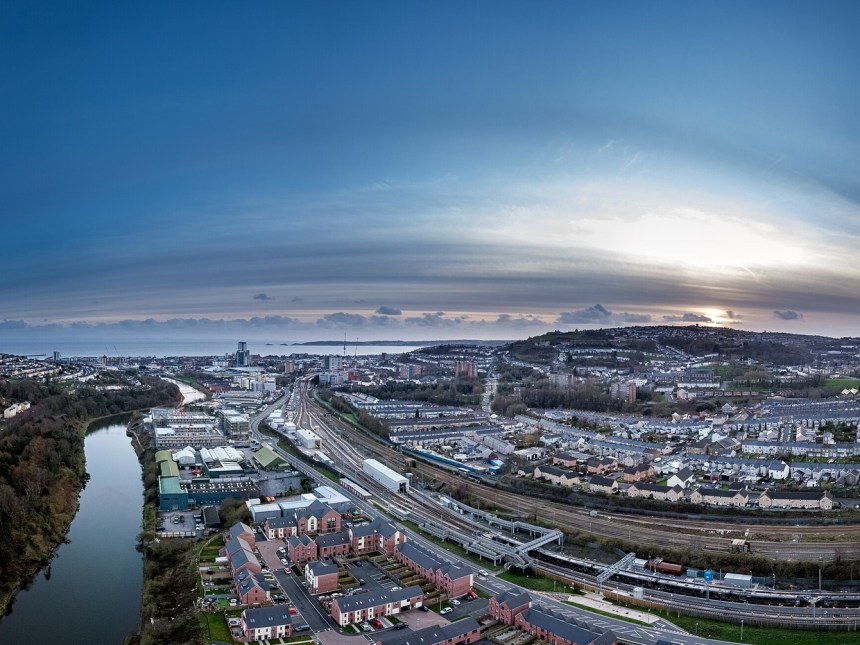 Aerial view of Swansea city centre at dusk, with the River Tawe and Kilvey Hill