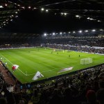 A packed Swansea.com Stadium under floodlights as the teams walk out for Swansea City's match against Manchester City in October 2025