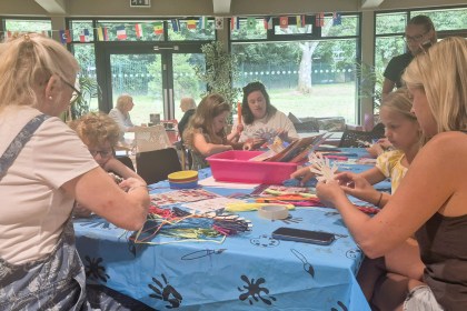 Children and adults making crafts around a table at Underhill Hub in Mumbles