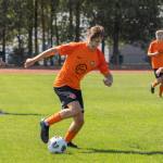 Pure Swansea full-back Dan Ingram running with the ball in an orange shirt