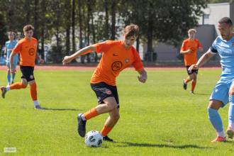 Pure Swansea full-back Dan Ingram running with the ball in an orange shirt