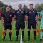 The Caerau Ely and Pure Swansea captains standing either side of the three match officials before kick-off