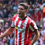 Ross Stewart celebrating a goal in a red and white striped Southampton shirt