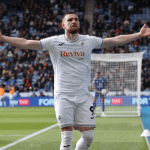 Zan Vipotnik with arms outstretched celebrating a goal in a white Swansea City shirt