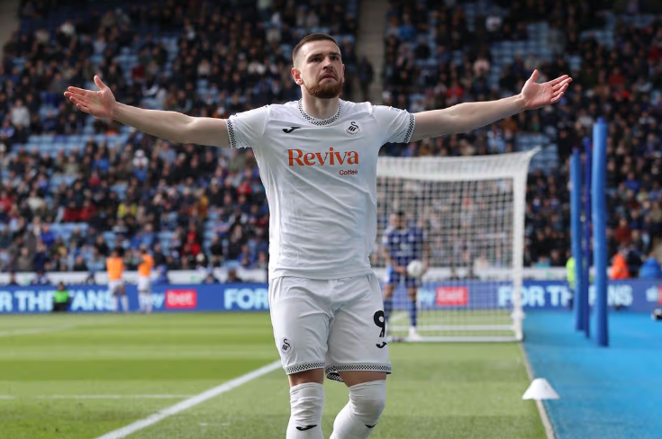 Zan Vipotnik with arms outstretched celebrating a goal in a white Swansea City shirt
